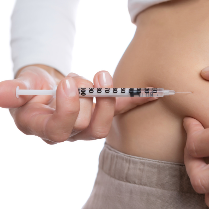 woman injecting semaglutide weight loss in tampa into stomach fat