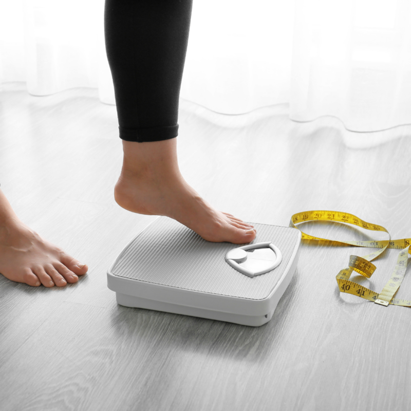 client stepping on a scale for semaglutide weight loss in tampa florida