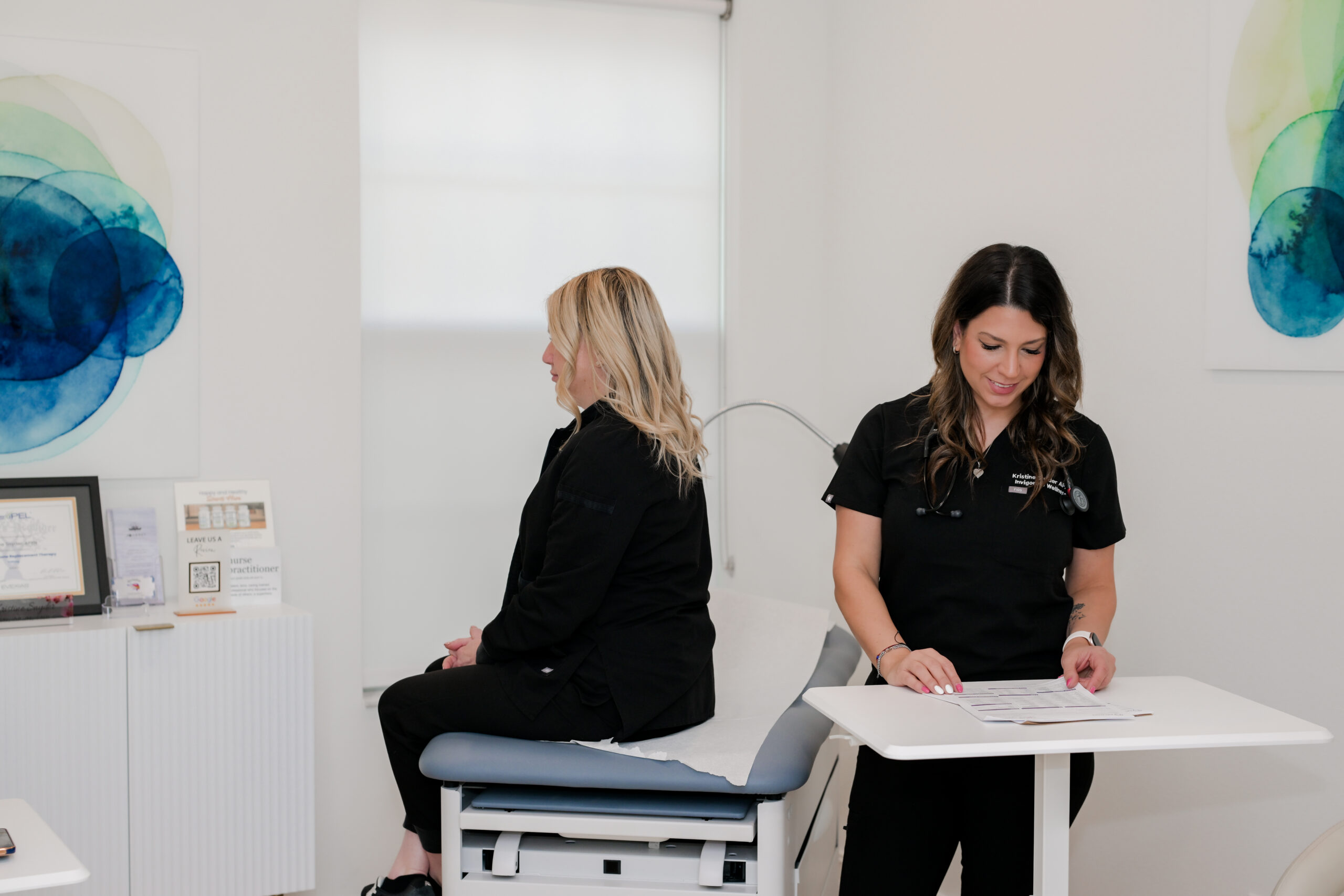 patient in medical office sitting on exam table